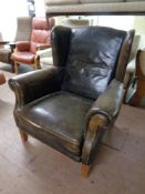 An early 20th century leather wingback armchair