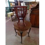 A 20th century continental circular mahogany two tier occasional table together with a stained