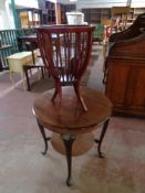 A 20th century continental circular mahogany two tier occasional table together with a stained