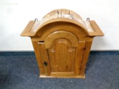 A continental oak arch topped wall cabinet