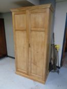 An antique pine double door wardrobe,
