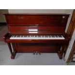 A Royale overstrung upright piano in a mahogany finish