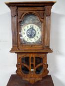 An oak cased Art Nouveau wall clock