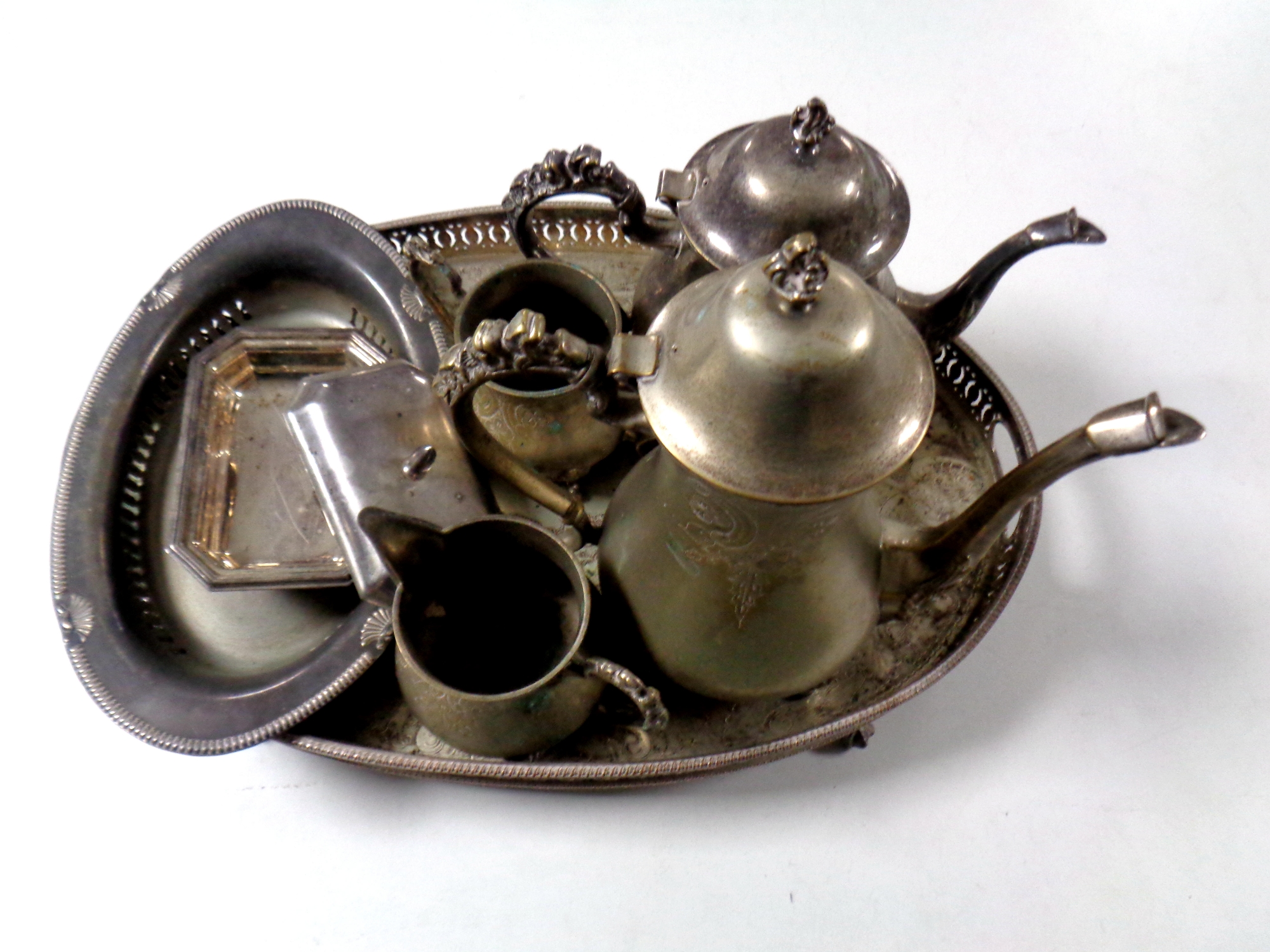 A four piece 20th century plated tea service on twin handled serving tray on raised feet together