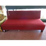 A 20th century day bed upholstered in a red fabric