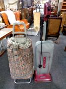 An Oreck upright vacuum together with a Rolser shopping trolley