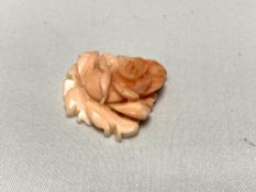 A small carving modelled as a rose spray