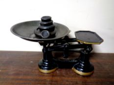 A set of cast iron kitchen scales with weights