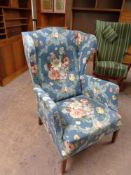 A 20th century wingback armchair upholstered in a floral fabric