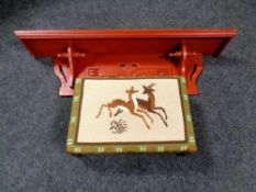 A painted wall shelf together with a carved beech tapestry upholstered footstool