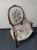 A carved beech salon armchair upholstered in a tapestry fabric (as found)