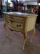 A cream and gilt two drawer French style chest