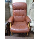 A brown leather adjustable armchair