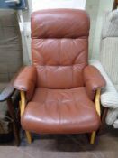 A brown leather adjustable armchair