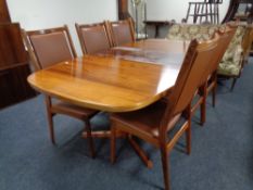 A 20th century Danish rosewood extending table with leaf and six high back chairs in brown leather