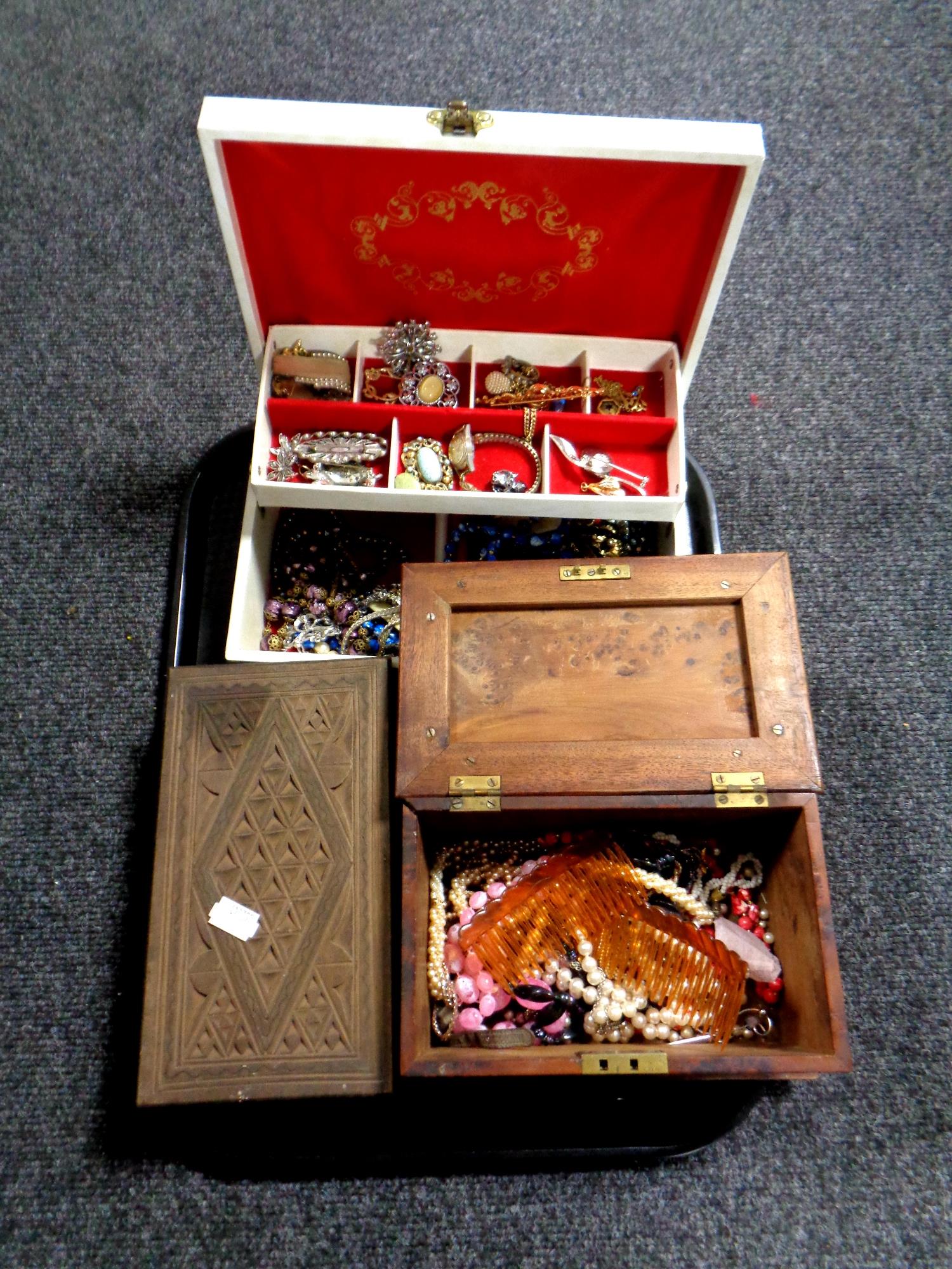 A tray containing three jewellery boxes containing a quantity of assorted costume jewellery,