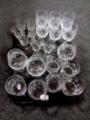 A tray of cut glass, lead crystal drinking glasses, etched liqueur glasses,