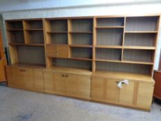 A Danish triple section bookcase fitted cupboards below,