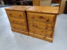A pair of pine three drawer bedside chests
