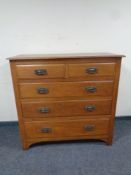 An Edwardian oak Arts & Crafts five drawer chest