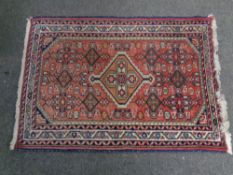 A Persian woolen fringed hearth rug, length 100 cm,