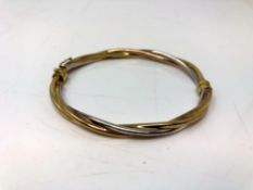 A 9ct gold three tone bangle. CONDITION REPORT: 6.