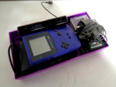 A Game Boy colour purple in carry case, together with six Game Boy games to include Mario and Yoshi,