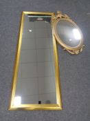 A gilt framed hall mirror together with an ornate plastic gilt framed mirror (largest 130 cm x 50