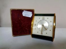 A Jaeger Le Coultre brass and green metal desk clock in original box