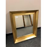 A contemporary golden framed mirror,