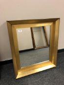 A contemporary golden framed mirror,