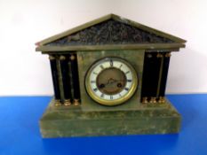 An antique onyx mantel clock with brass and enamelled dial