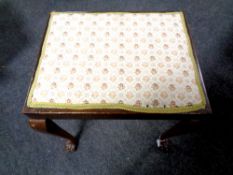 An early 20th century beech dressing table stool