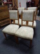 A set of four continental dining chairs upholstered in a tapestry fabric