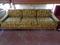 A mid 20th century Scandinavian three seater settee upholstered in a floral fabric