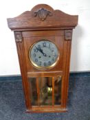 An Edwardian oak cased eight day wall clock with silvered dial