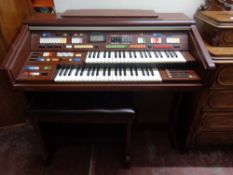 A Technics electric organ with stool (continental wiring)