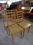 A set of four contemporary oak dining chairs