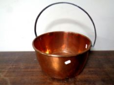 A 19th century copper cast iron handled jam pan