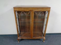 A 20th century mahogany double door display cabinet on Queen Anne legs,