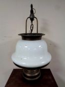 An early 20th century copper ship's style hanging light fitting with opaque glass shade