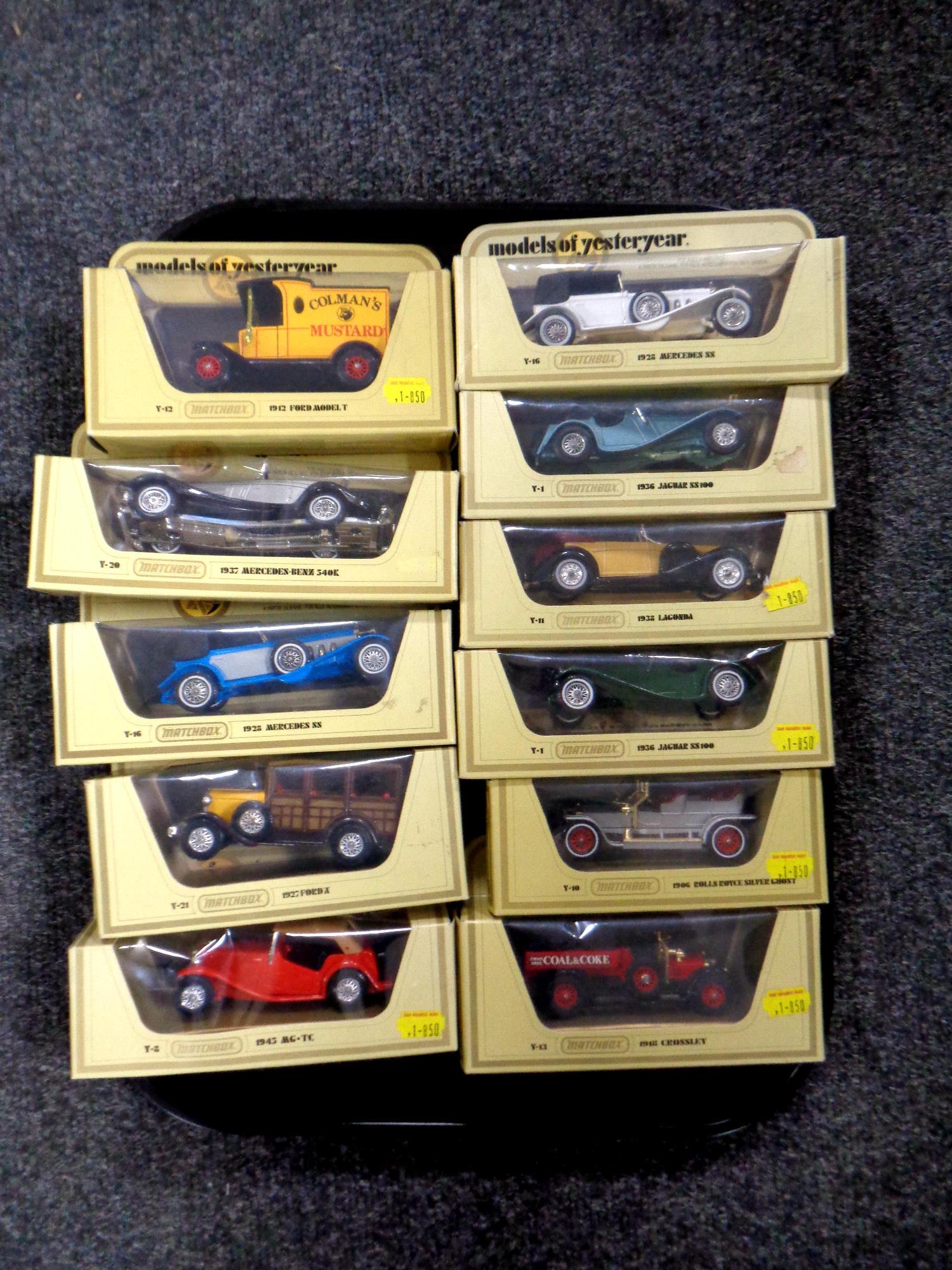 A tray containing 11 Matchbox Models of Yesteryear die cast delivery vehicles and classic cars,