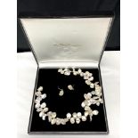 A silver mounted pearl necklace and matching earring set