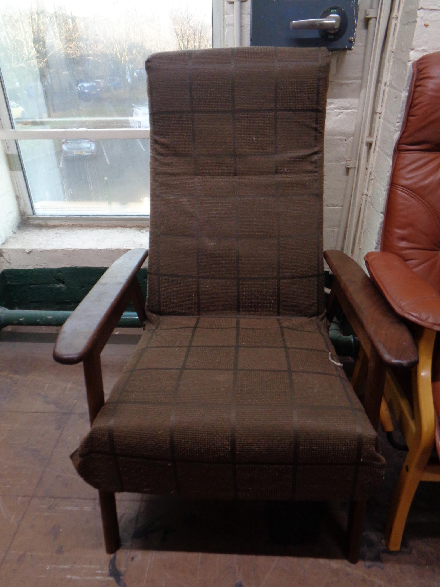 A mid 20th century teak framed adjustable armchair with foot rest