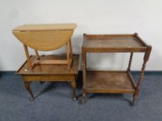 A 20th century walnut sewing box on Queen Anne legs together with a barley twist two tier trolley