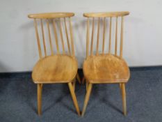 A pair of Ercol elm and beech spindle back dining chairs