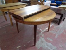 A 20th century circular rosewood extending table with leaf