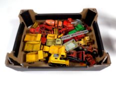 A box containing a quantity of 20th century play worn die cast farm vehicles,