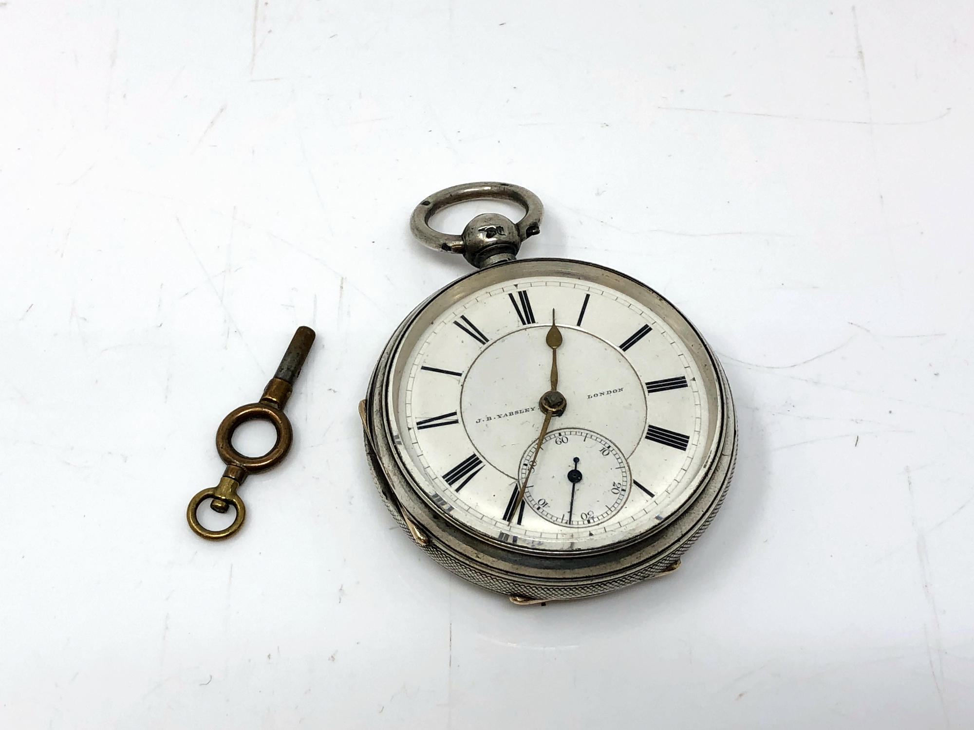 A silver open face key wound pocket watch by JB Yabsley,