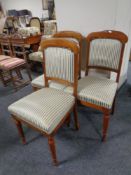 A set of three antique dining chairs upholstered in a classical striped fabric